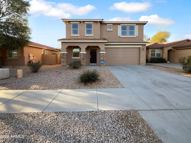 traditional-style home featuring a garage, stone siding, driveway, and stucco siding