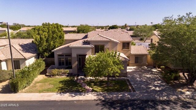 2109 W Wildhorse Dr, Chandler, AZ 85286 - mediterranean / spanish-style house featuring stucco siding, a tiled roof, and concrete driveway