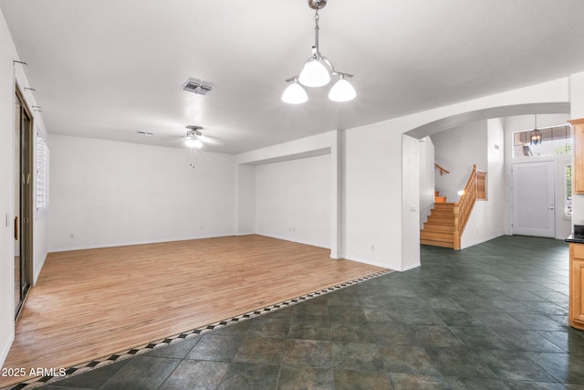 2109 W Wildhorse Dr, Chandler, AZ 85286 - unfurnished living room featuring arched walkways, a ceiling fan, and stairway