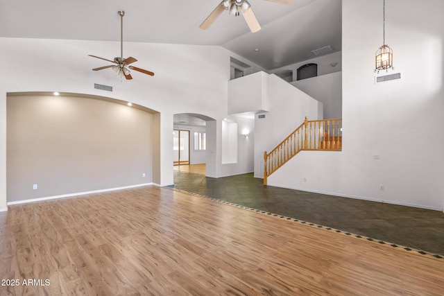 2109 W Wildhorse Dr, Chandler, AZ 85286 - unfurnished living room with a ceiling fan, arched walkways, wood finished floors, stairway, and high vaulted ceiling