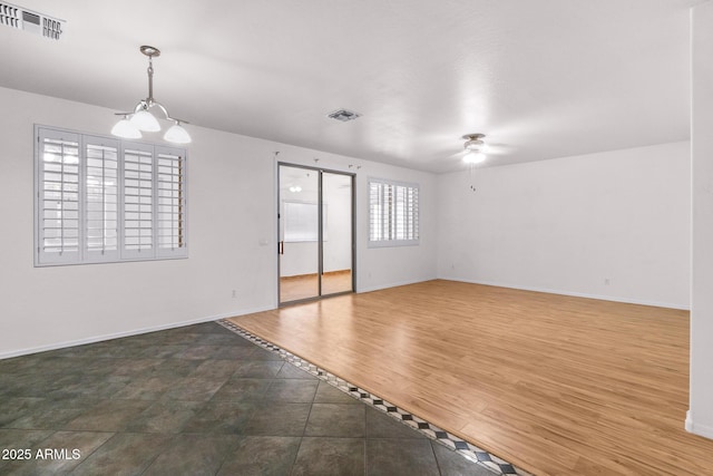 2109 W Wildhorse Dr, Chandler, AZ 85286 - spare room featuring a ceiling fan and a chandelier