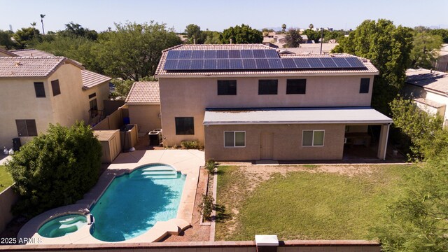 2109 W Wildhorse Dr, Chandler, AZ 85286 - back of property featuring roof mounted solar panels, a patio, stucco siding, and a pool with connected hot tub