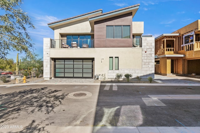 contemporary home with a balcony and a garage