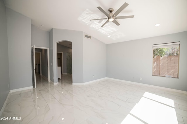 spare room featuring lofted ceiling and ceiling fan