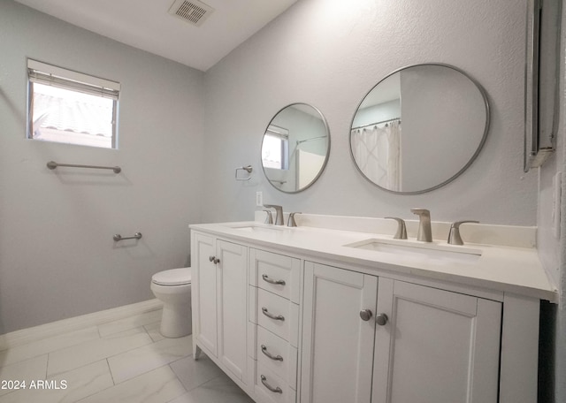 bathroom featuring vanity and toilet