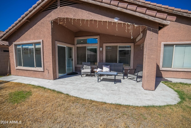 rear view of house featuring a lawn and a patio area