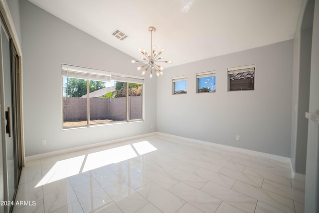 unfurnished room featuring a chandelier and vaulted ceiling