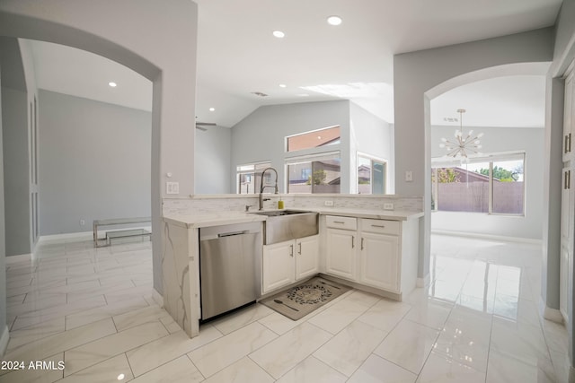 kitchen with lofted ceiling, a wealth of natural light, and dishwasher