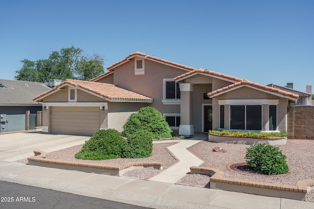 5596 W Mercer Ln, Glendale, AZ 85304 - mediterranean / spanish-style house featuring stucco siding, an attached garage, concrete driveway, and a tile roof