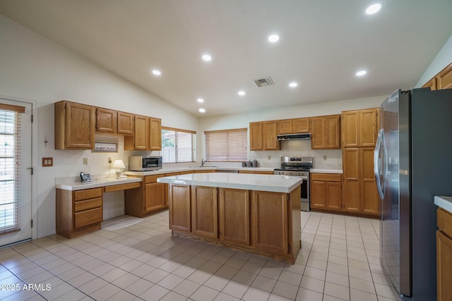 5596 W Mercer Ln, Glendale, AZ 85304 - kitchen with stainless steel appliances, extractor fan, light countertops, a center island, and vaulted ceiling