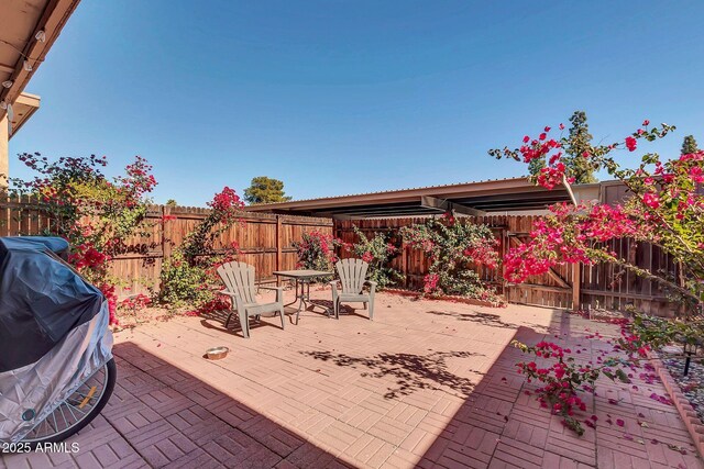 view of patio with grilling area and a fenced backyard