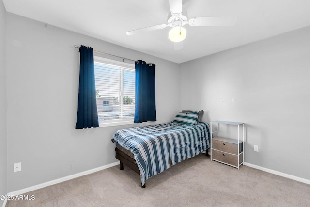 carpeted bedroom with a ceiling fan and baseboards