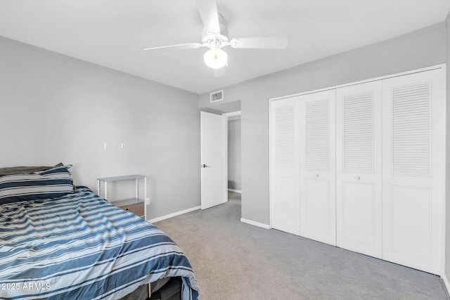 bedroom featuring a ceiling fan, visible vents, baseboards, a closet, and carpet flooring