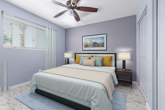 bedroom featuring ceiling fan, light wood-style floors, and baseboards