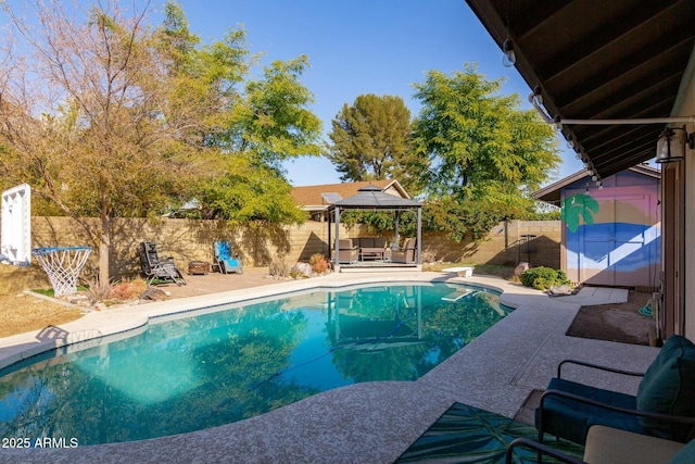 view of pool featuring a gazebo, a storage shed, a diving board, and a patio area