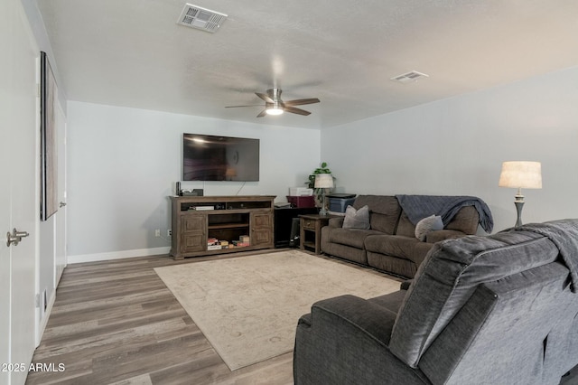 living room featuring hardwood / wood-style flooring, a textured ceiling, and ceiling fan