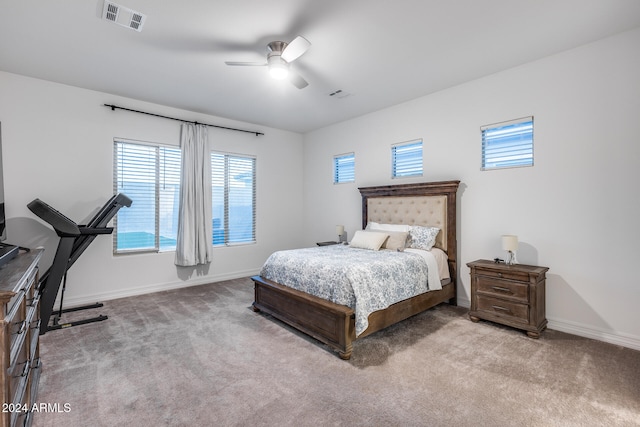 bedroom with ceiling fan and light colored carpet