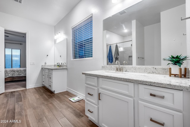 bathroom featuring vanity, wood-type flooring, and an enclosed shower