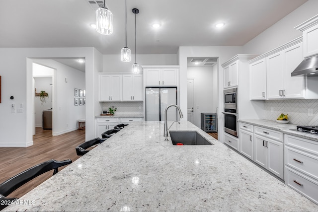 kitchen featuring sink, white cabinetry, and stainless steel appliances