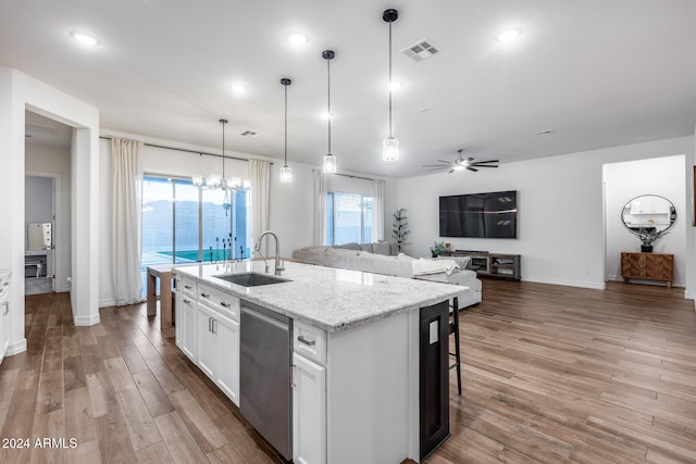 kitchen with hardwood / wood-style floors, ceiling fan with notable chandelier, sink, stainless steel dishwasher, and white cabinetry