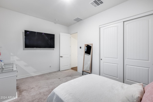 carpeted bedroom with a closet