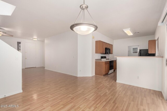 2652 E Riviera Dr, Chandler, AZ 85249 - unfurnished living room with light wood-style floors, baseboards, and a skylight