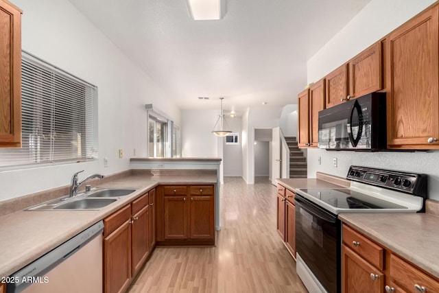 2652 E Riviera Dr, Chandler, AZ 85249 - kitchen featuring range with electric cooktop, black microwave, dishwasher, a sink, and light wood-style flooring