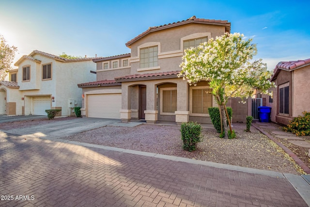 2652 E Riviera Dr, Chandler, AZ 85249 - mediterranean / spanish house featuring a tiled roof, driveway, stucco siding, and an attached garage