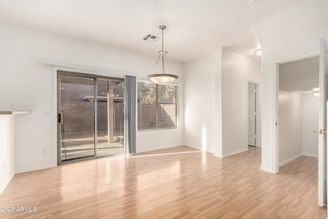 2652 E Riviera Dr, Chandler, AZ 85249 - unfurnished dining area featuring light wood-style floors and baseboards