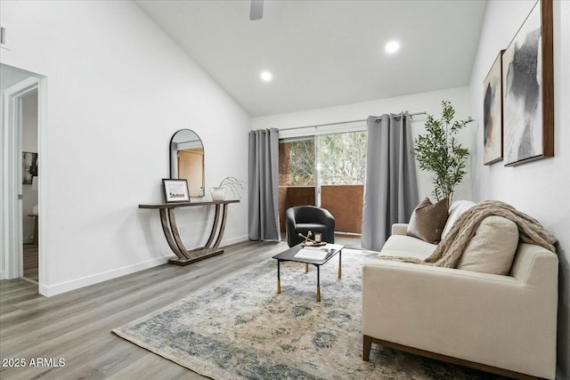 living room with hardwood / wood-style floors and high vaulted ceiling