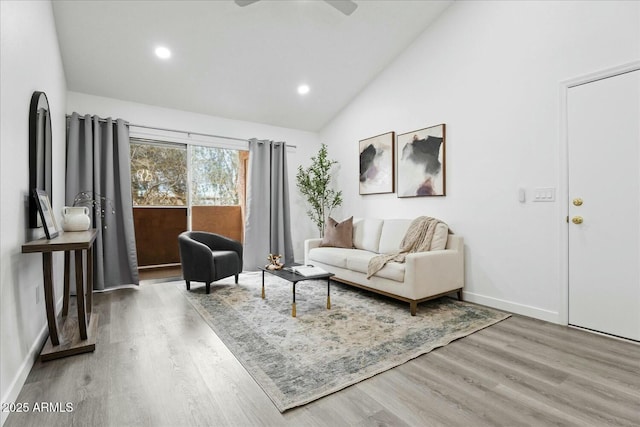 living room with vaulted ceiling and wood-type flooring