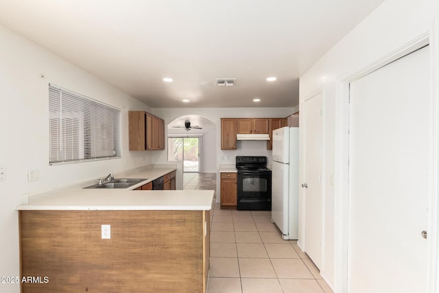 5439 W Sands Rd, Glendale, AZ 85301 - kitchen featuring black appliances, under cabinet range hood, a sink, a peninsula, and light tile patterned flooring