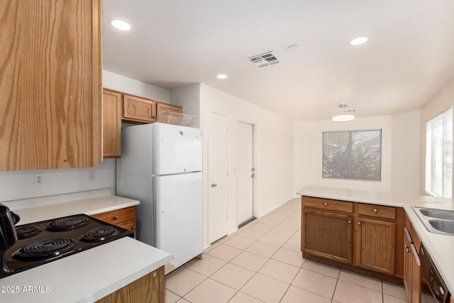 5439 W Sands Rd, Glendale, AZ 85301 - kitchen featuring black appliances, light countertops, brown cabinets, light tile patterned floors, and recessed lighting