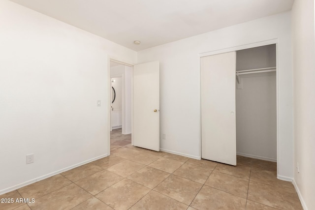 5439 W Sands Rd, Glendale, AZ 85301 - unfurnished bedroom featuring light tile patterned floors, a closet, and baseboards