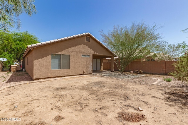 5439 W Sands Rd, Glendale, AZ 85301 - rear view of property featuring a tiled roof, fence, and stucco siding