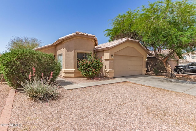 5439 W Sands Rd, Glendale, AZ 85301 - view of front of house with stucco siding, an attached garage, driveway, and a tiled roof