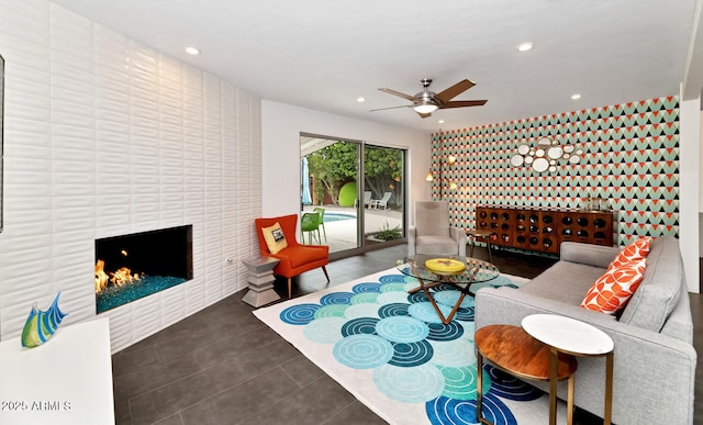 living area with recessed lighting, a ceiling fan, a fireplace, and tile patterned flooring