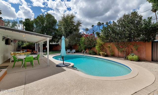 view of swimming pool with a fenced in pool, a patio, outdoor dining area, and a fenced backyard