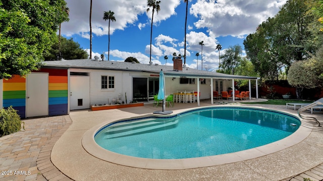 view of pool featuring outdoor dining space, a fenced in pool, and a patio