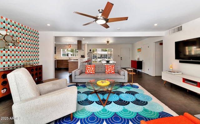 living room featuring visible vents, recessed lighting, finished concrete flooring, and a ceiling fan