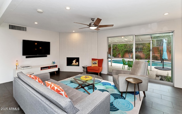 living room featuring visible vents, recessed lighting, a large fireplace, and ceiling fan