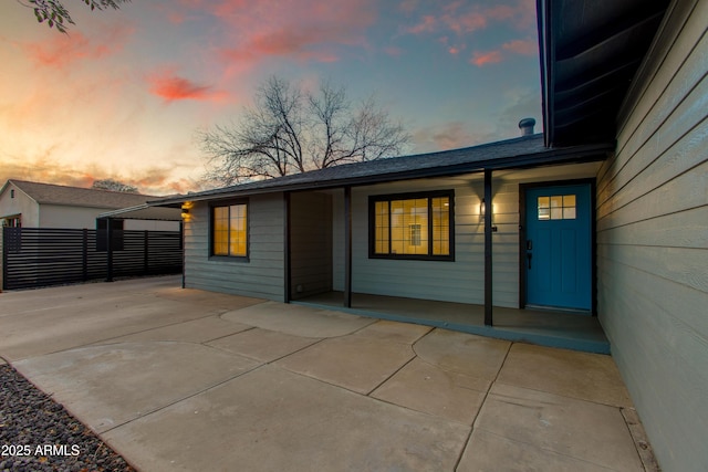 back of house at dusk with fence