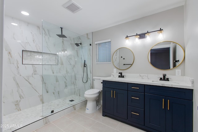 bathroom featuring a marble finish shower, visible vents, toilet, and a sink