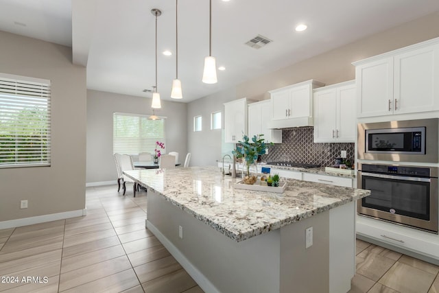 kitchen featuring white cabinetry, a wealth of natural light, pendant lighting, and appliances with stainless steel finishes