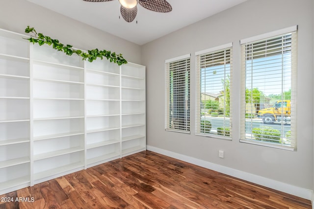 unfurnished room with ceiling fan and dark wood-type flooring