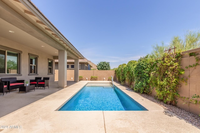 view of pool featuring outdoor lounge area and a patio