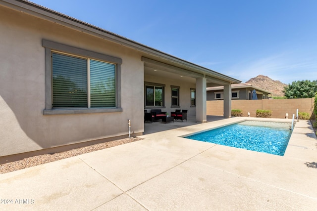 view of swimming pool with a patio area and an outdoor living space