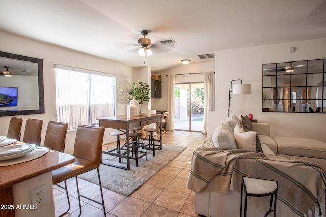 4386 E Mine Shaft Rd, San Tan Valley, AZ 85143 - dining area with light tile patterned flooring, visible vents, vaulted ceiling, and ceiling fan