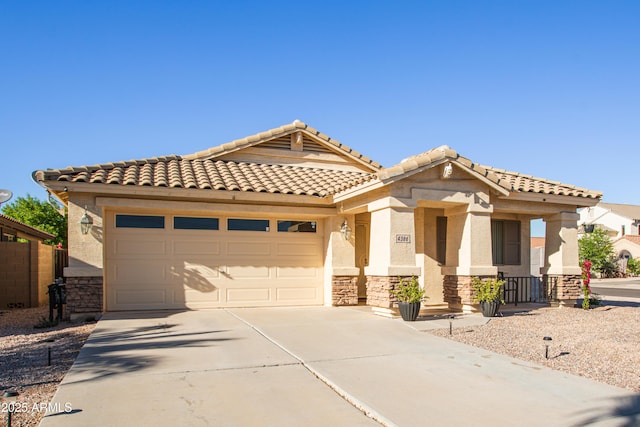 4386 E Mine Shaft Rd, San Tan Valley, AZ 85143 - view of front of home featuring stucco siding, an attached garage, stone siding, a tiled roof, and driveway