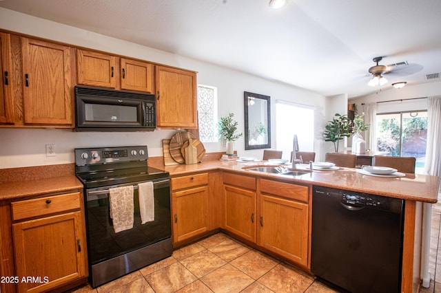 4386 E Mine Shaft Rd, San Tan Valley, AZ 85143 - kitchen with a sink, ceiling fan, a peninsula, black appliances, and brown cabinets